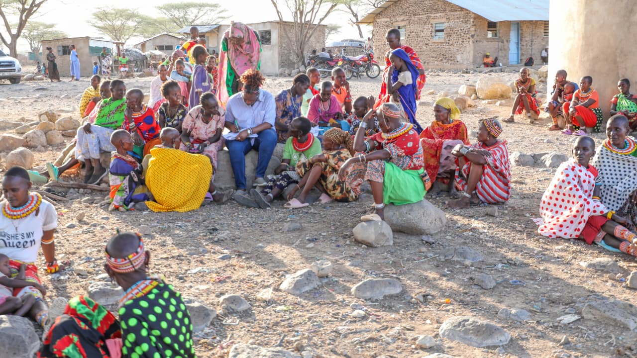 Assistant Director of Land Adjudication and Settlement, Joyce Kamire, with women parting in the exercise at Olturot