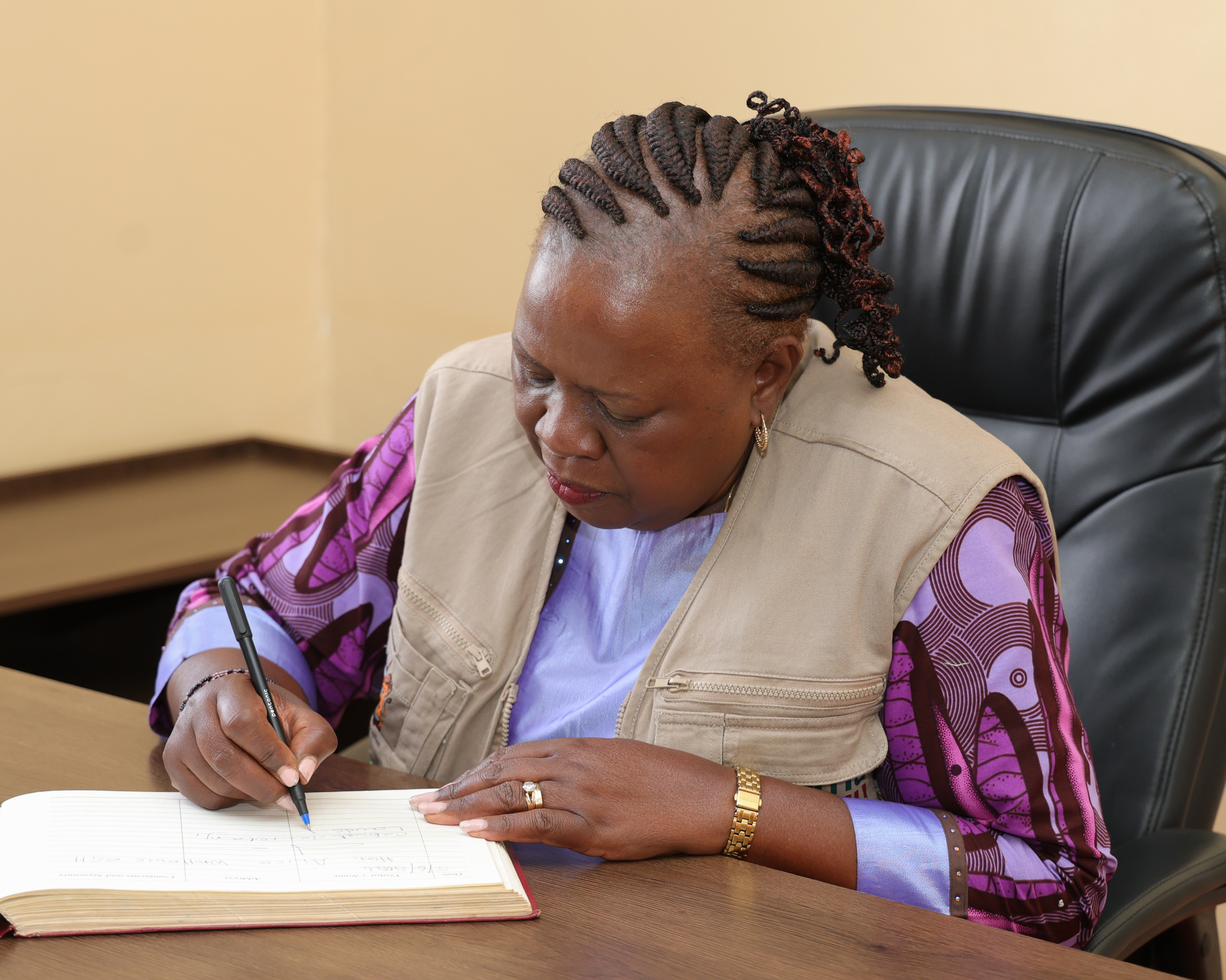 Cabinet Secretary Alice Wahome signs the visitors’ book during the official opening ceremony of the Kamwangi Land Registry
